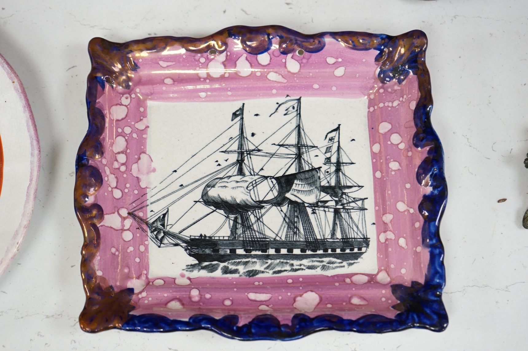 A 19th century Sunderland pink lustre ‘ship’ plaque and an HMS, Duke of Wellington plate, largest 24cm in diameter